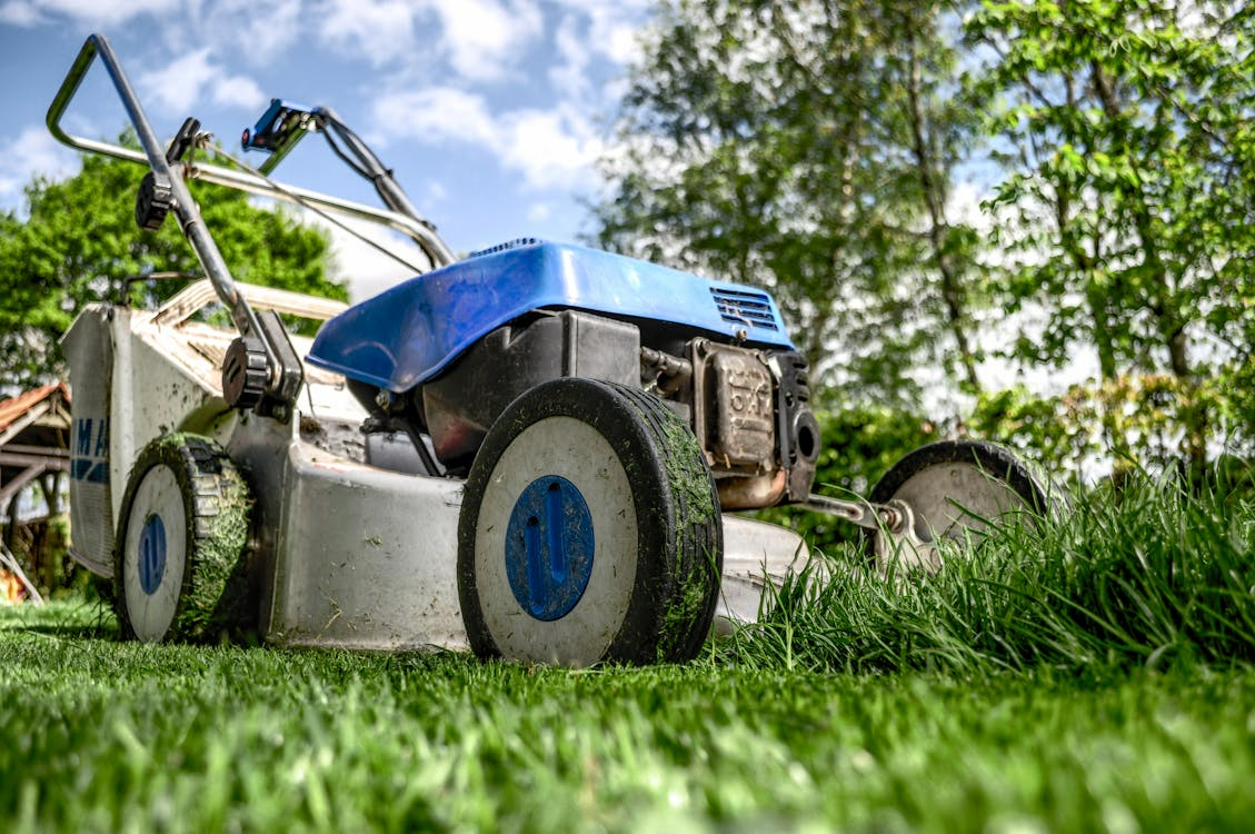 Lawn mower on lush green grass