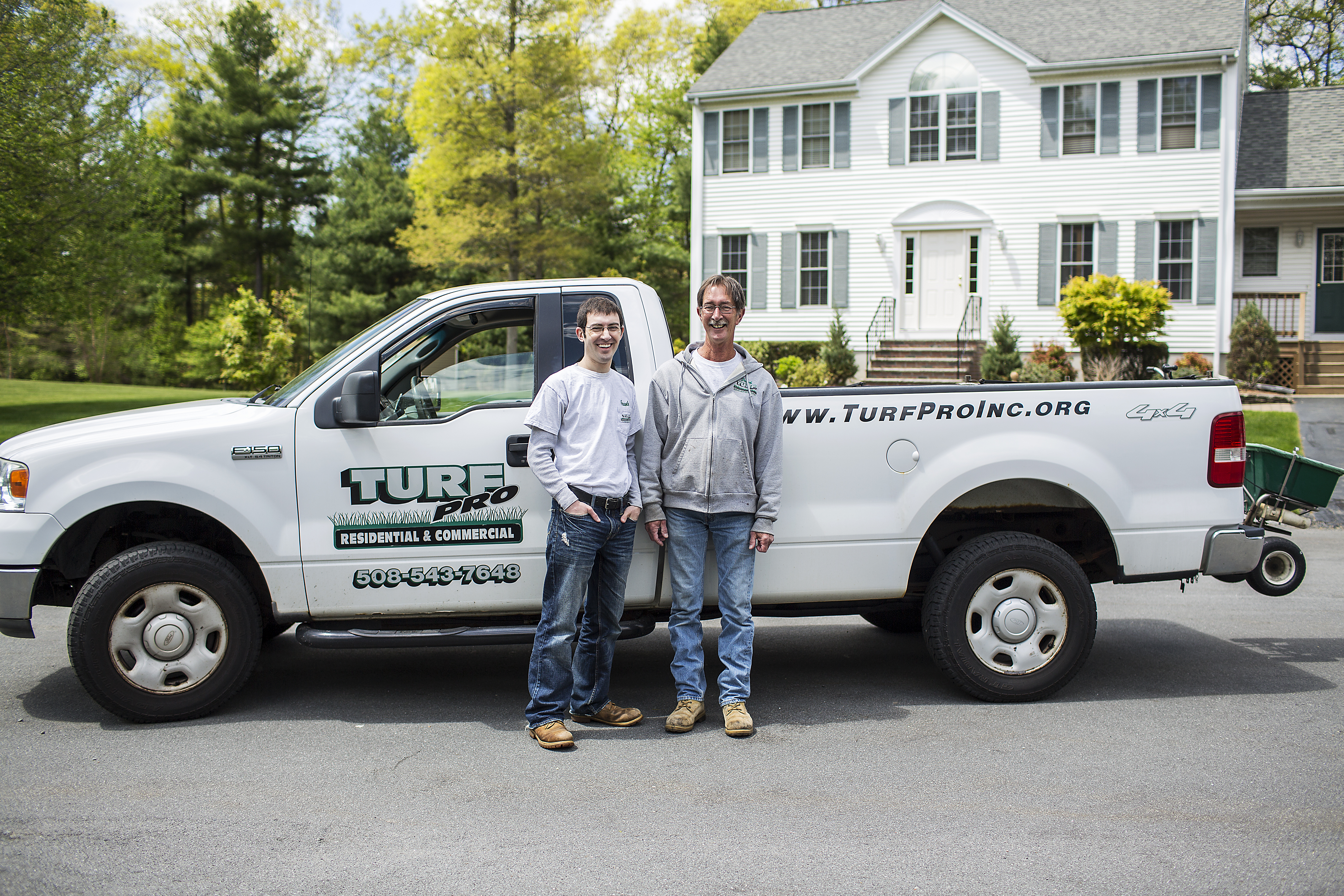 Turf Pro, Inc. family team in front of company truck